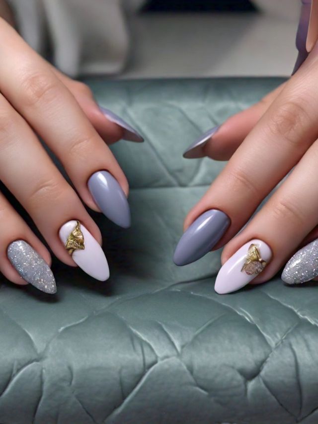 A woman's hands flaunting luxurious grey and silver nail designs.