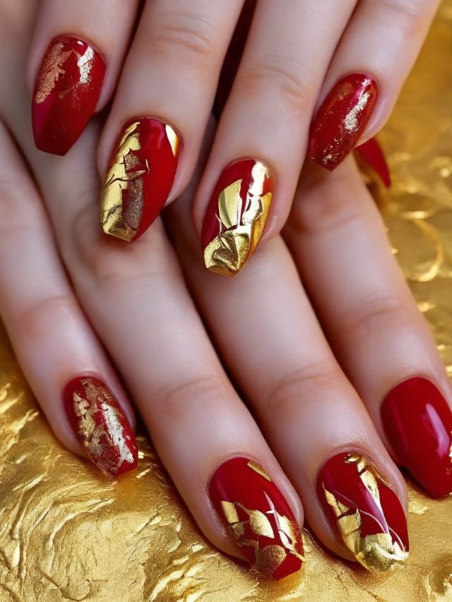 A woman with fall red nail designs on a gold background.