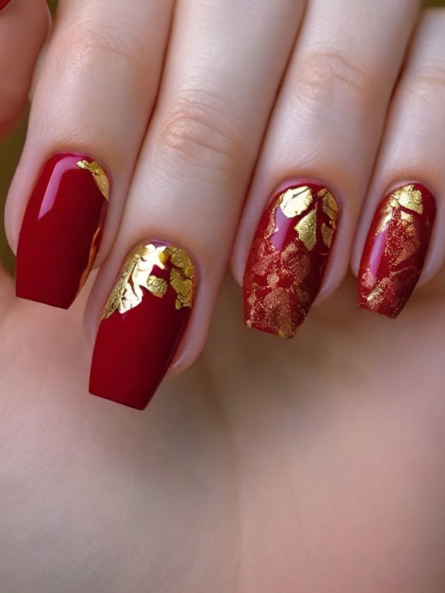 A hand with stunning red nail designs.