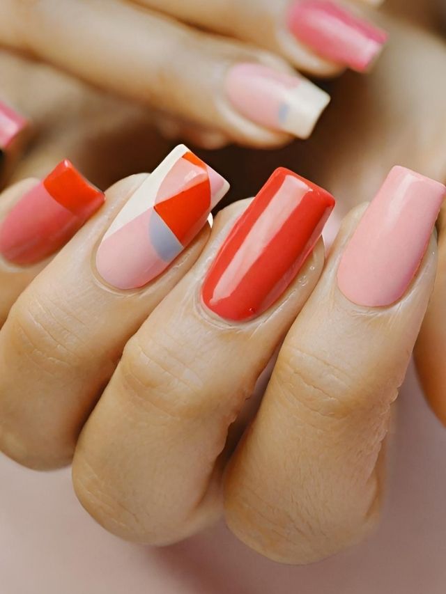 A woman's hands with pink and white manicured nails.