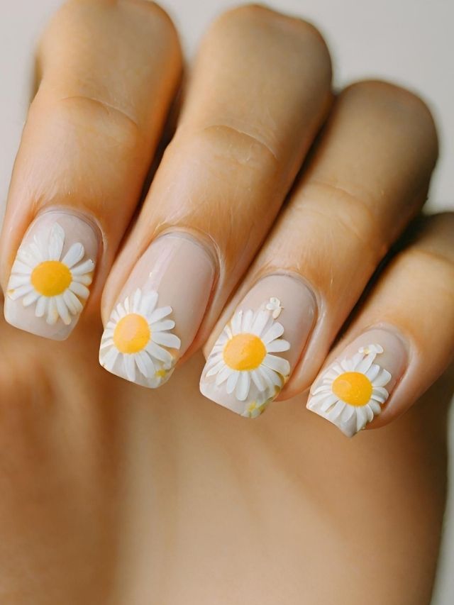 A woman's nails adorned with beautiful daisies, perfect for Valentine's Day nail art.