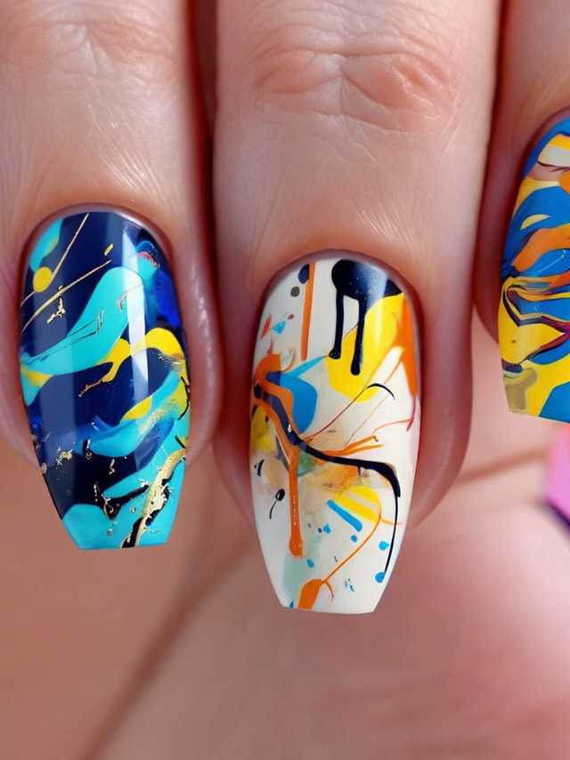 A woman's nails with colorful paint splatters on them.