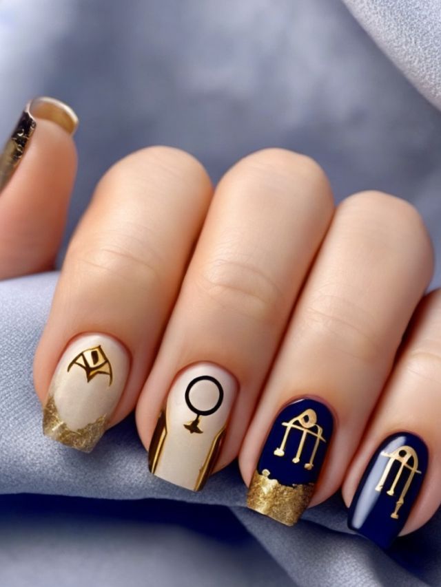 Egyptian nails with gold and blue designs.
