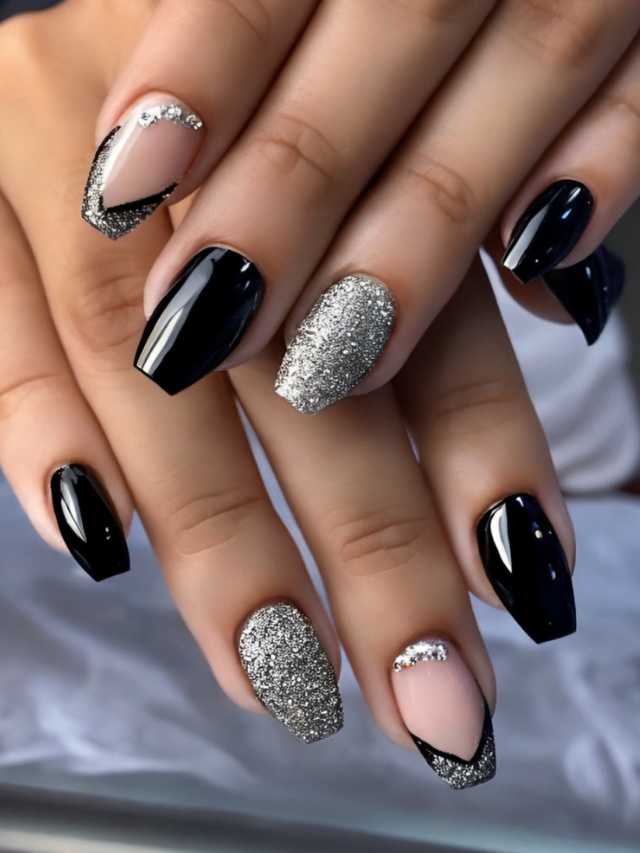 A woman's hand with black and silver nails.