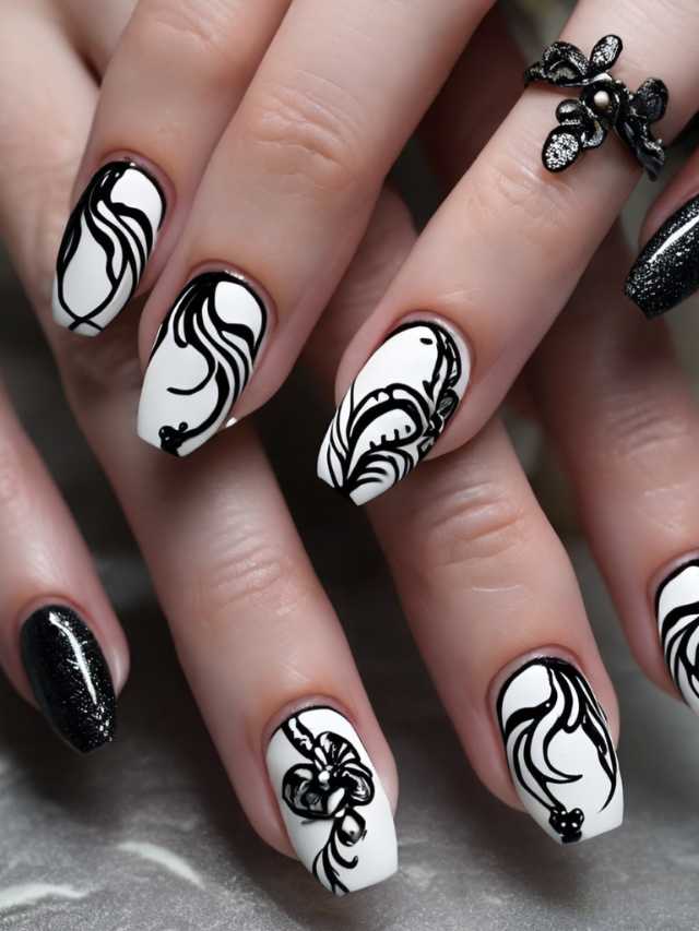 A woman's nails are decorated with black and white designs.