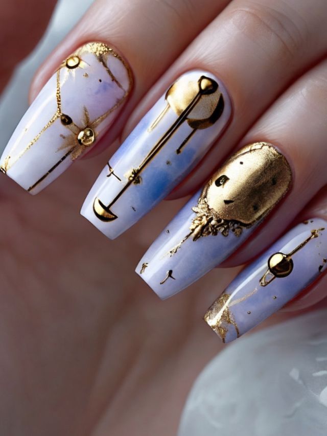 A woman's nails are decorated with gold stars and moons.