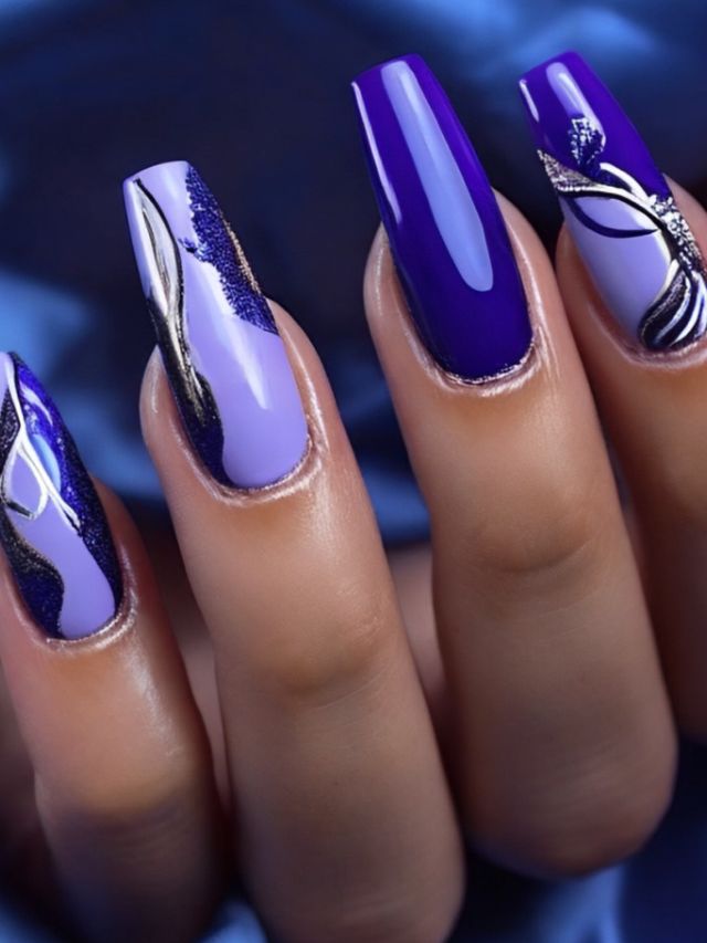 A woman's nails with purple and blue designs.
