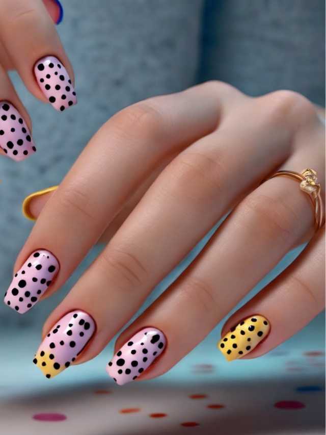 A woman's hands with polka dot nails.