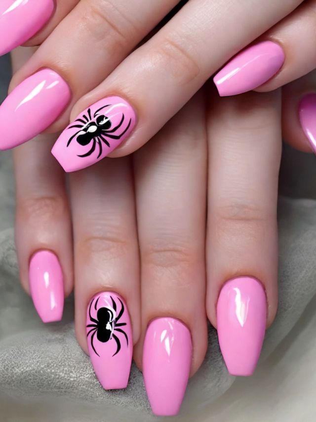 Pink nails with a spider design on them.