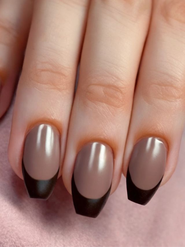 A woman's hand with brown and black nails.