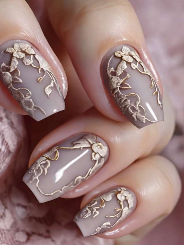 A woman's nails are decorated with gold and silver designs.