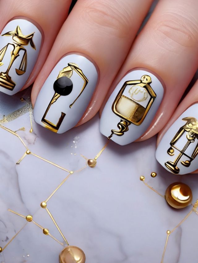 A woman's nails with astrological symbols on them.