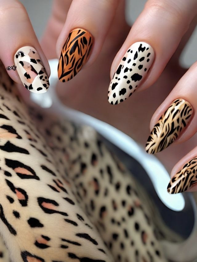 A woman is holding a leopard print nail art design.