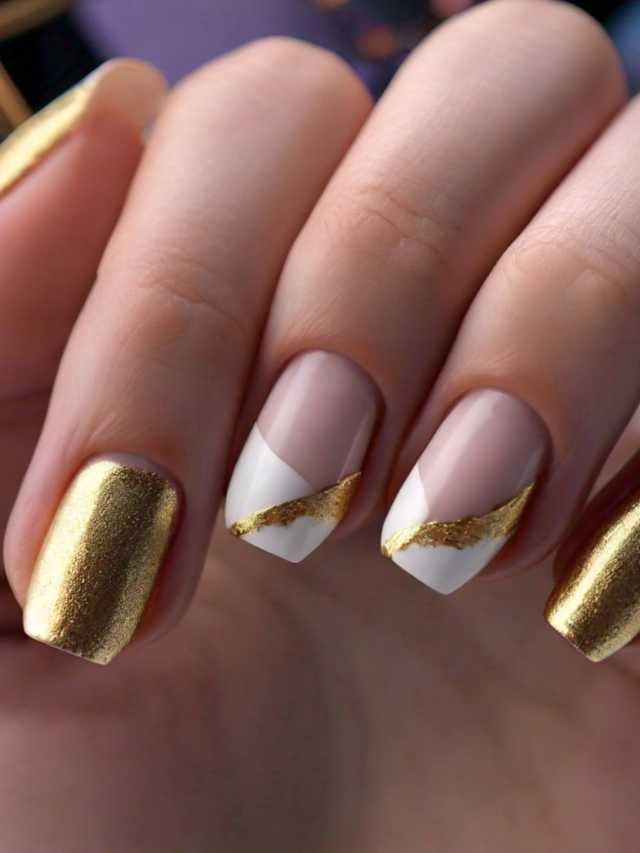 A woman's nails with gold and white designs.