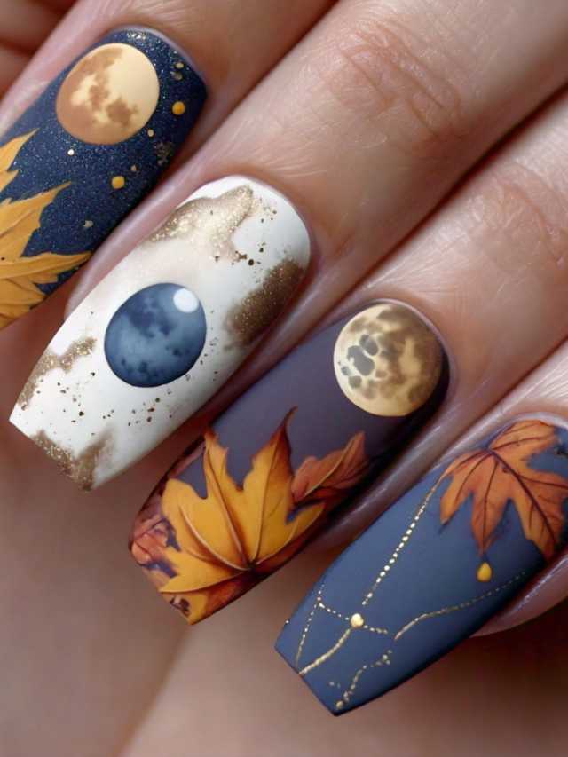 A woman's nails with autumn leaves and a moon on them.