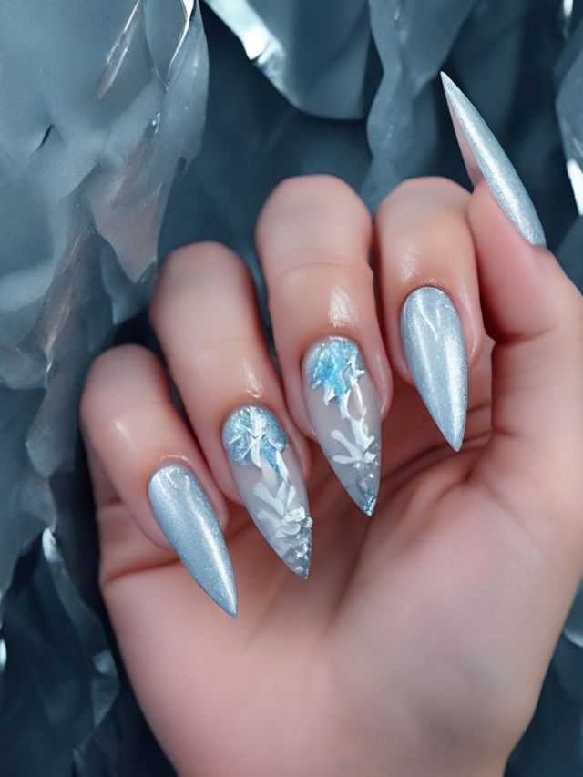 A woman holding a silver nail with a snowflake design.
