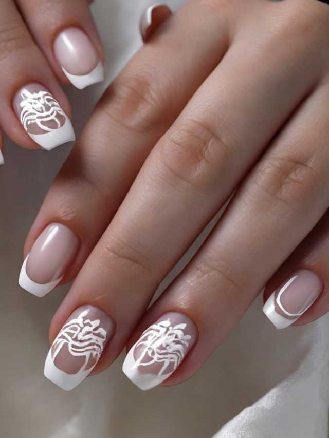 A woman's nails with white designs on them.