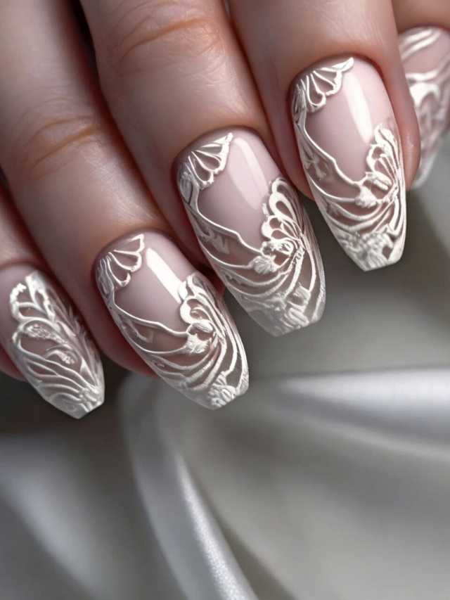 A woman's nails with white lace designs on them.