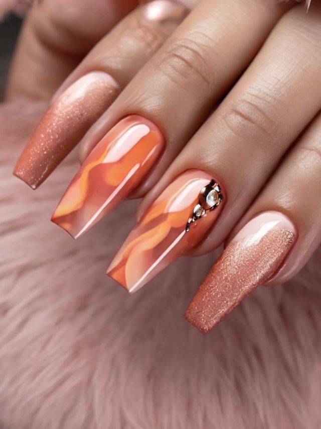 A woman's hand with orange and pink nails.