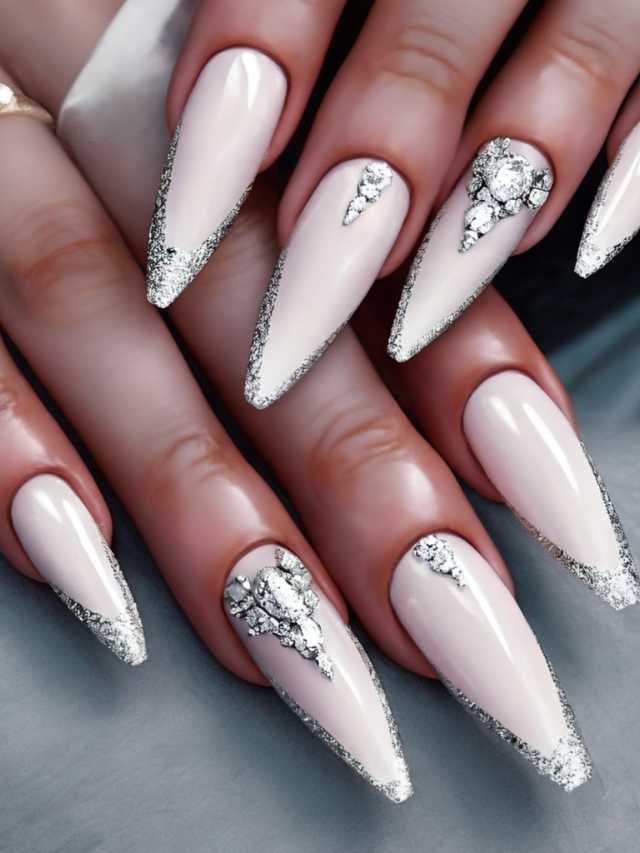 A woman's nails with white and silver accents.