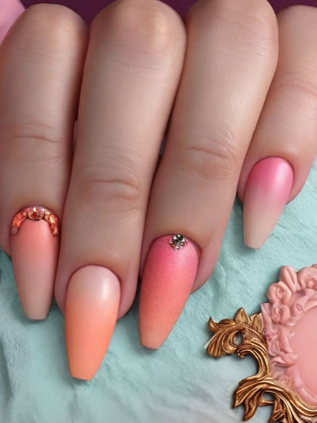 A woman's hand with pink and orange ombre nails.