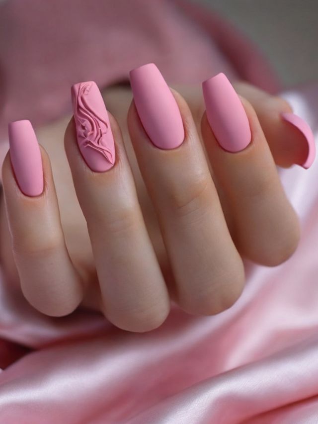 A woman's pink nails with a design on them.