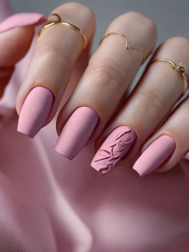 A woman with pink nails and gold rings.