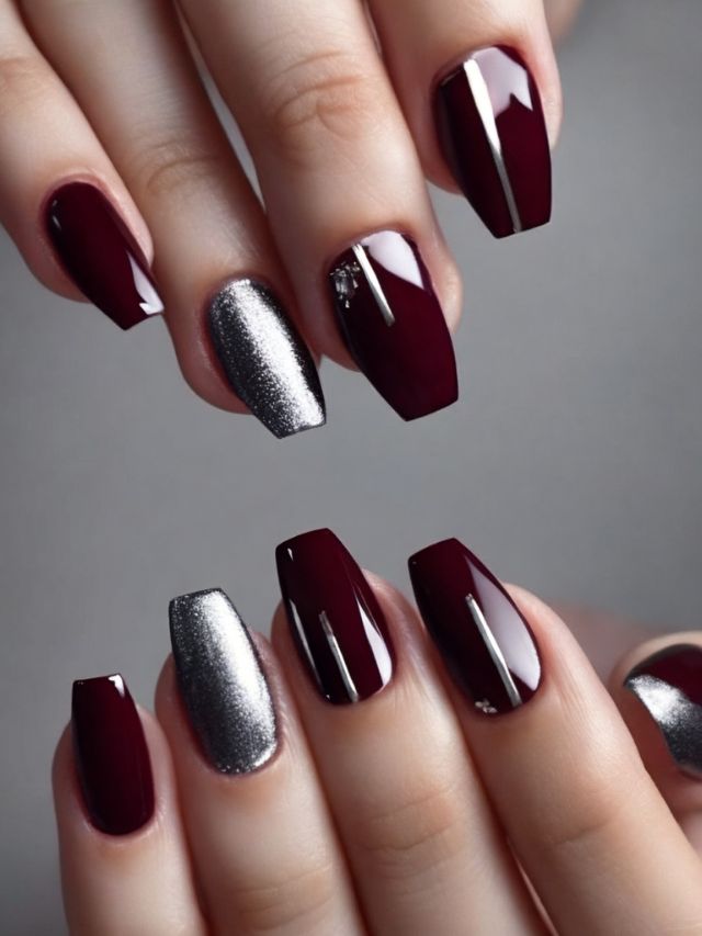 A woman's hands with burgundy and silver nails.