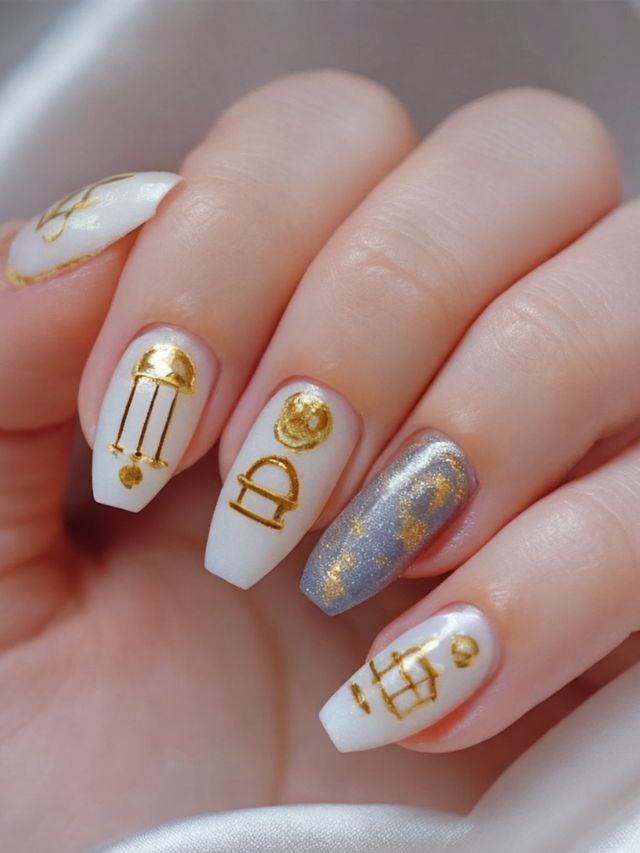 A woman's nails with gold and white designs on them.