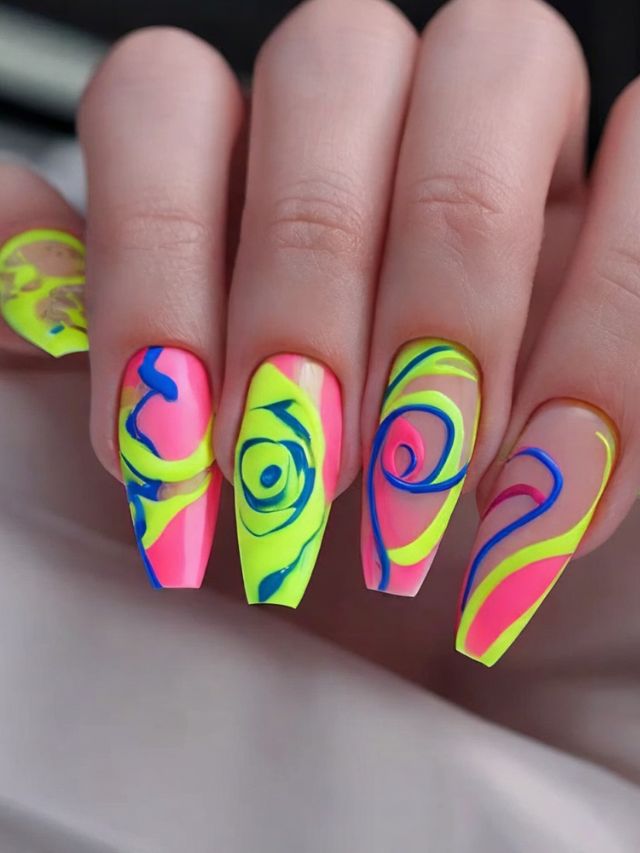 A woman's nails are decorated with neon colors and swirls.