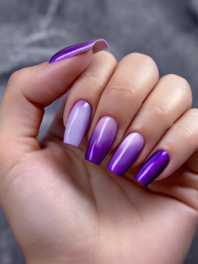 A woman's hand with purple and white nails.