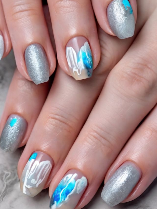 A woman's hands with blue and silver nail art.