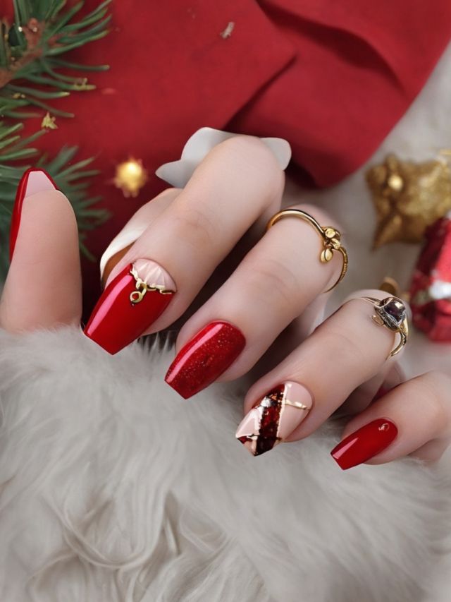 A gorgeous woman's hand with red nail polish adorned with Christmas ornaments.