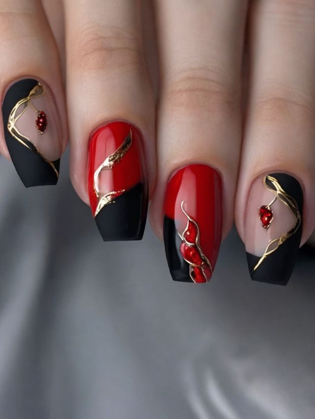 A woman with almond nails featuring red and black colors, embellished with gold accents.