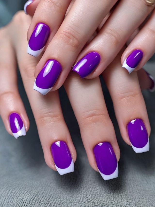 A woman's hands with purple and white nails.