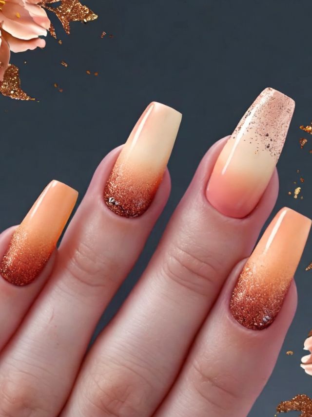 A woman's nails with orange and gold accents.
