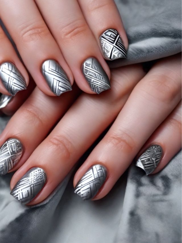 A woman's hands with silver nail designs.