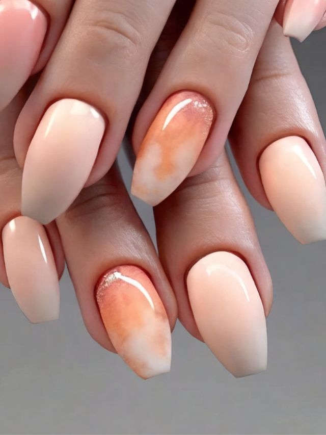 A woman's hands with peach and white nails.