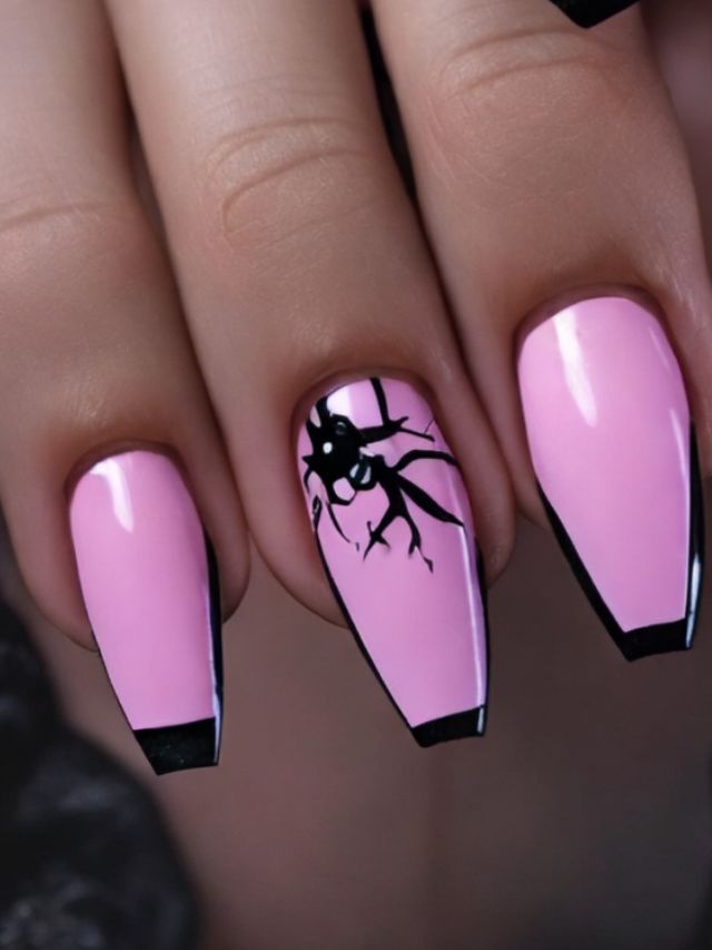 A woman's pink nails with black and white designs.