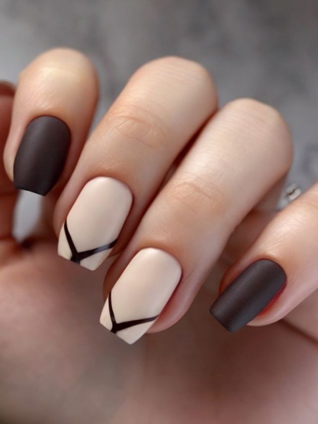 A woman's hand with brown and beige nails.