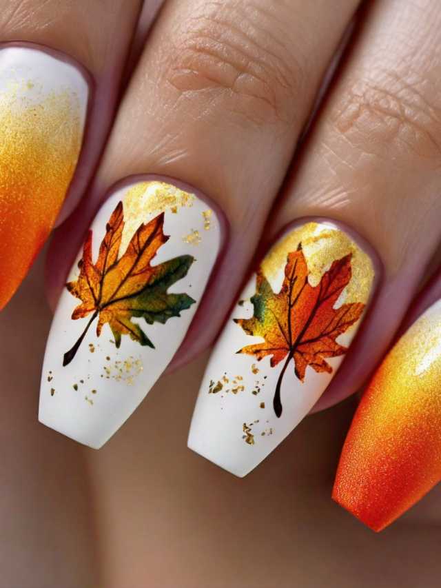 A woman's nails with autumn leaves on them.