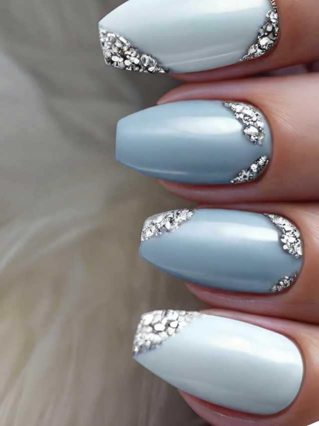 A woman's nails with blue and silver accents.