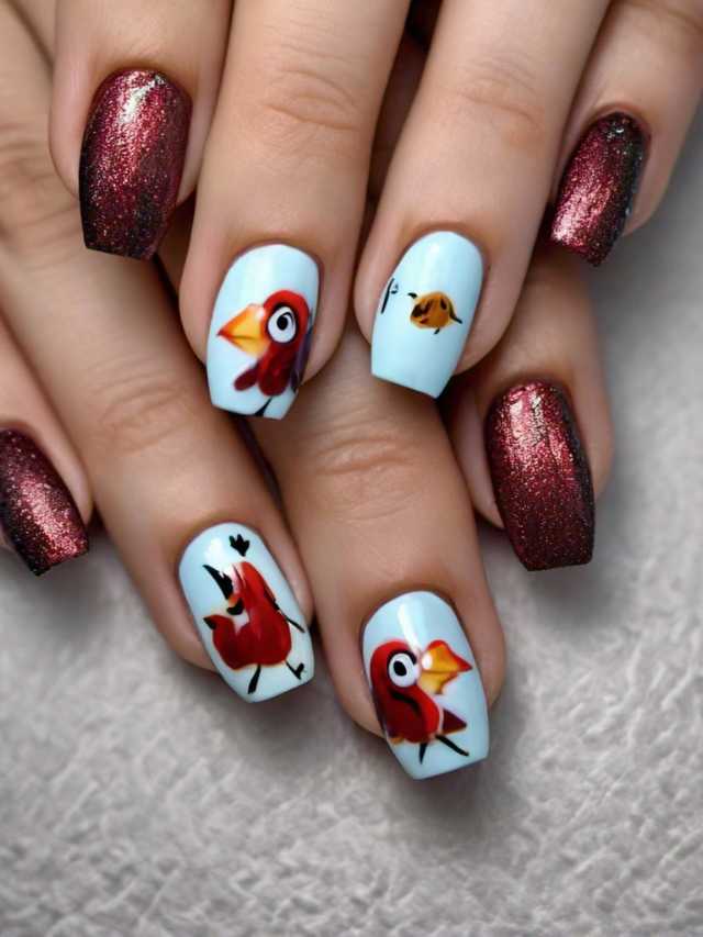 A woman's nails are decorated with red and blue birds.