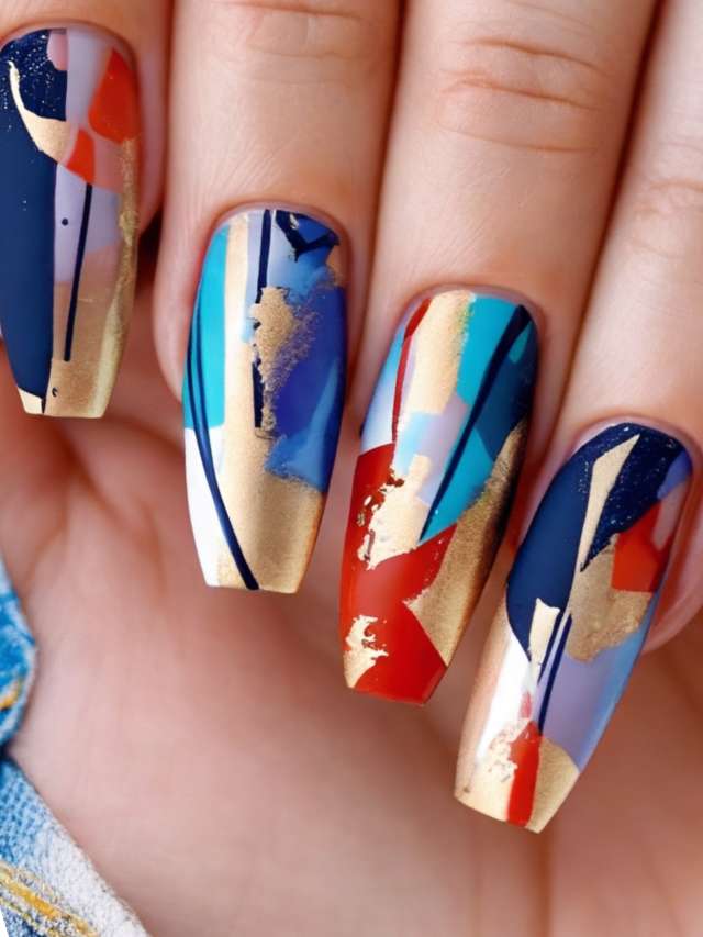 A woman's nails are decorated with gold and blue paint.