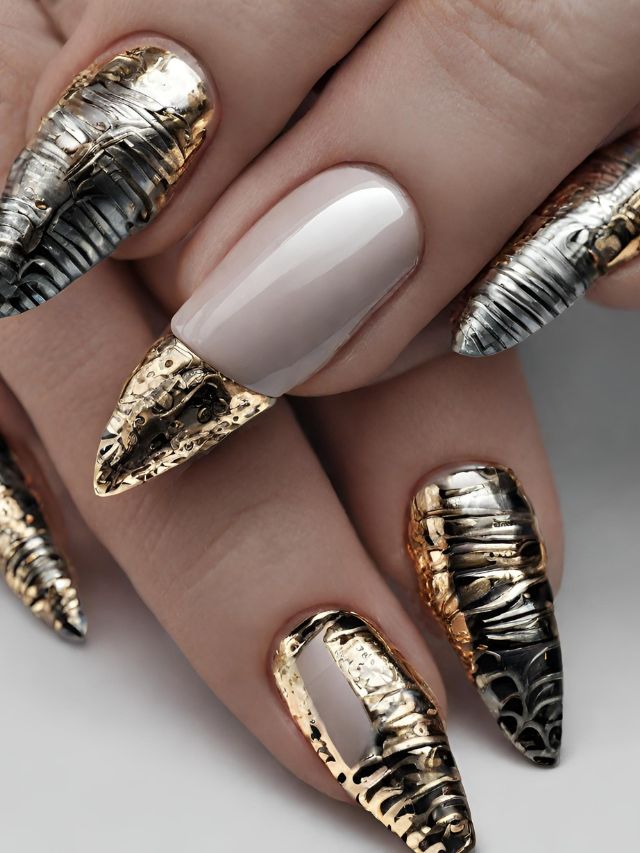A woman's nails with gold and silver designs.