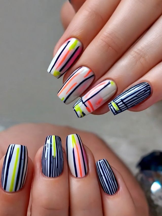 A woman's hands with colorful striped nails.