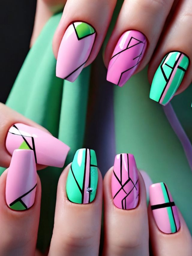 A close up of pink and green nail designs.
