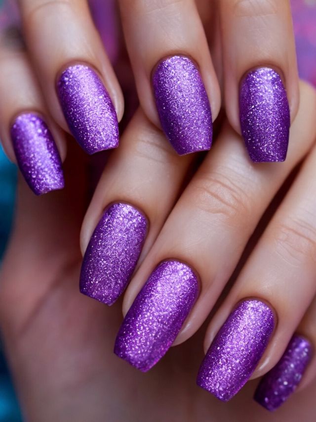 Beautiful purple glitter nail polish on a woman's hand.