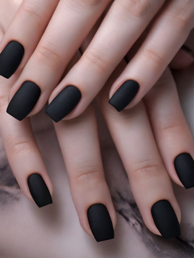 A woman's hands showcasing stunning black matte nails, perfect for January.