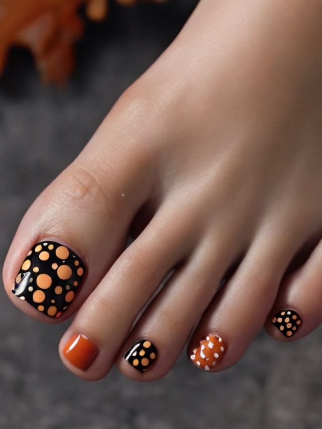 A woman's toes with cute black and orange polka dot fall nail designs.